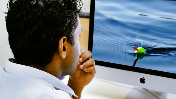 Man considering email phishing lure